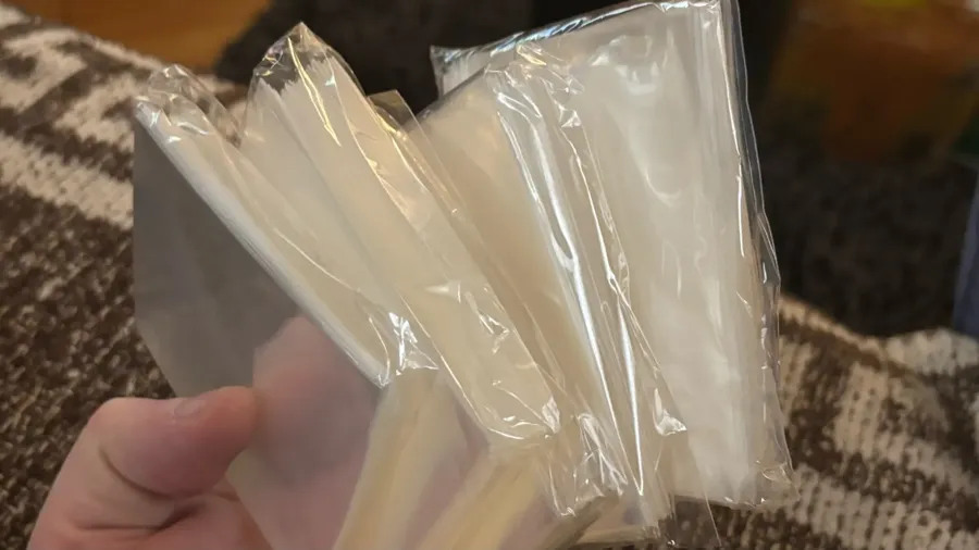 Buyer photo of clear soft sleeves fanned out in hand